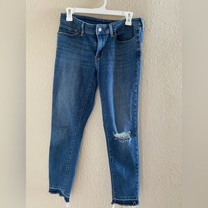 Levi low rise crop jeans with hole in left knee